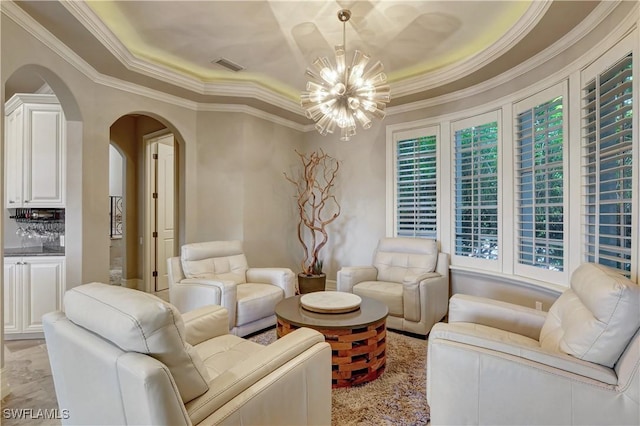 1947 Gordon River Ln, Naples, FL 34104 - living area featuring visible vents, ornamental molding, a tray ceiling, a chandelier, and arched walkways