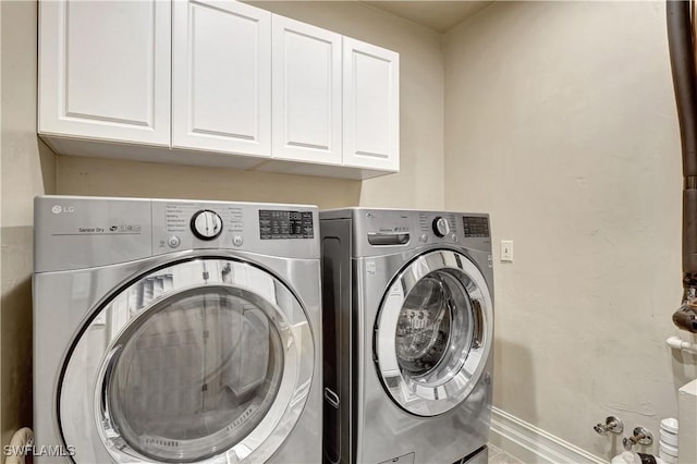 1947 Gordon River Ln, Naples, FL 34104 - laundry area with separate washer and dryer, cabinet space, and baseboards