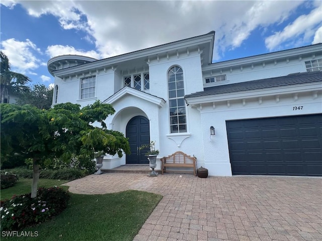 1947 Gordon River Ln, Naples, FL 34104 - view of front facade with decorative driveway, a garage, and stucco siding