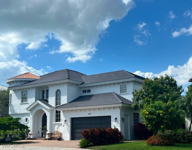1947 Gordon River Ln, Naples, FL 34104 - mediterranean / spanish-style house with a garage, stucco siding, and driveway