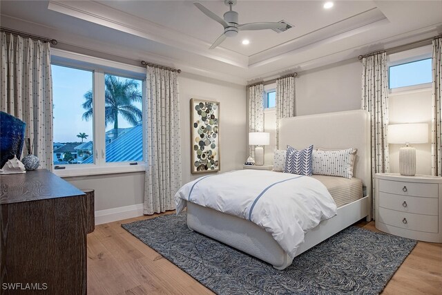 1380 Pelican Ave, Naples, FL 34102 - bedroom featuring baseboards, a raised ceiling, multiple windows, and light wood finished floors