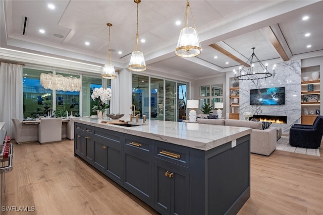 1380 Pelican Ave, Naples, FL 34102 - kitchen with a notable chandelier, light wood finished floors, a large fireplace, and a sink