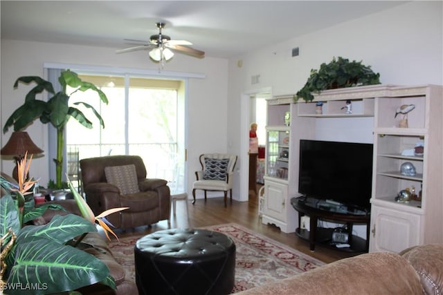 living area featuring ceiling fan, wood finished floors, and visible vents