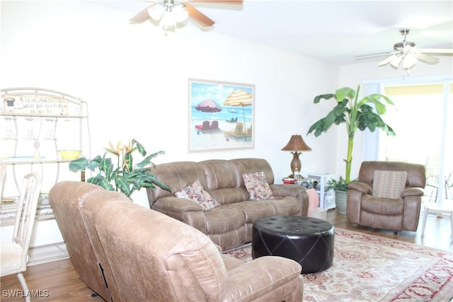 living room with ceiling fan, wood finished floors, and plenty of natural light