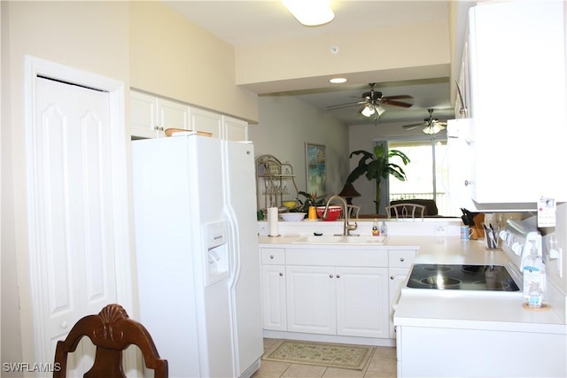 kitchen with white fridge with ice dispenser, ceiling fan, white cabinets, and a sink