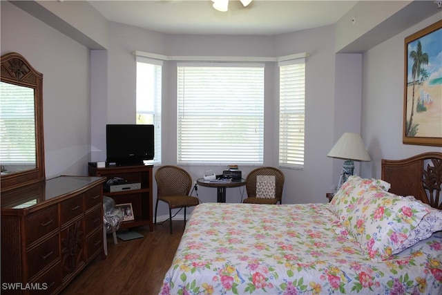 bedroom with dark wood-style flooring