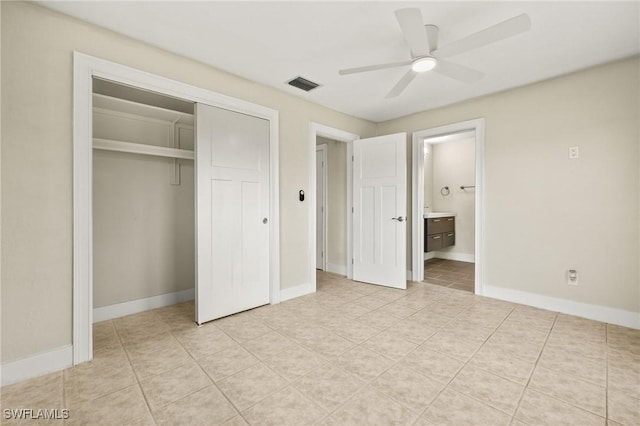 unfurnished bedroom with light tile patterned flooring, ensuite bath, baseboards, visible vents, and a closet