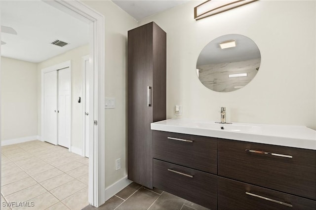 bathroom with vanity, tile patterned flooring, baseboards, and visible vents