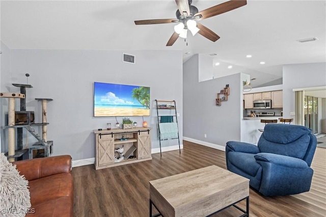 living room with baseboards, wood finished floors, and lofted ceiling