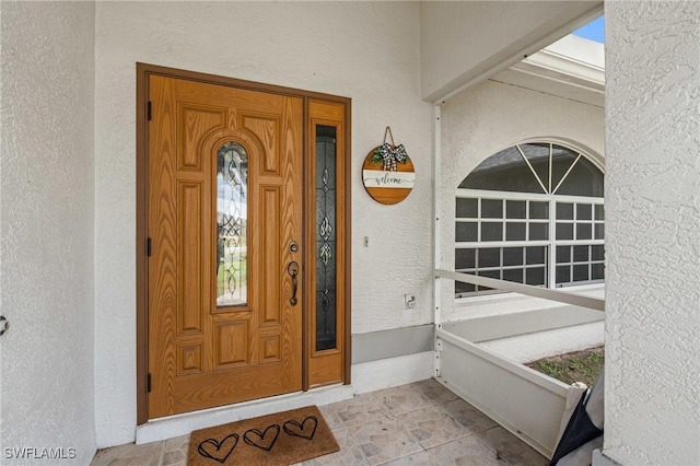 view of exterior entry featuring stucco siding