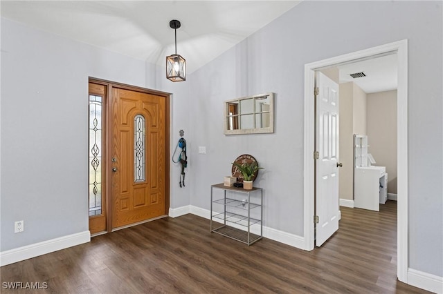 foyer entrance featuring baseboards, dark wood finished floors, and visible vents