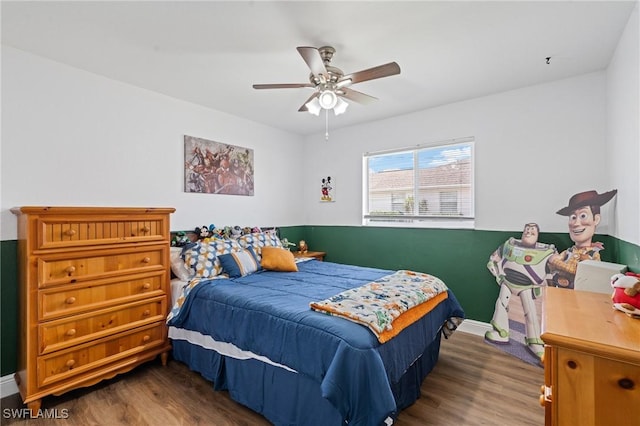 bedroom with baseboards, a ceiling fan, and wood finished floors