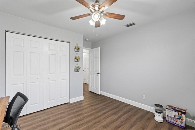 unfurnished office featuring baseboards, visible vents, and wood finished floors