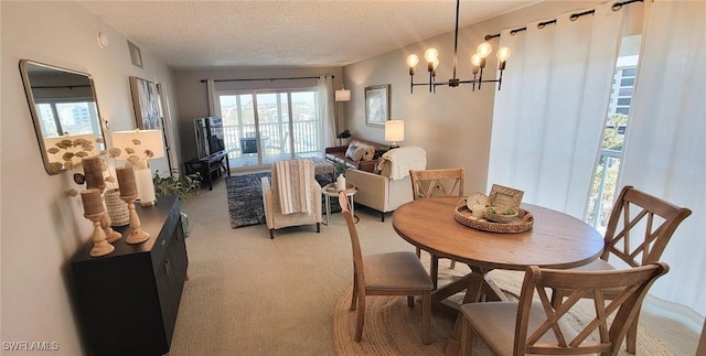 dining room with light carpet, a textured ceiling, and a chandelier