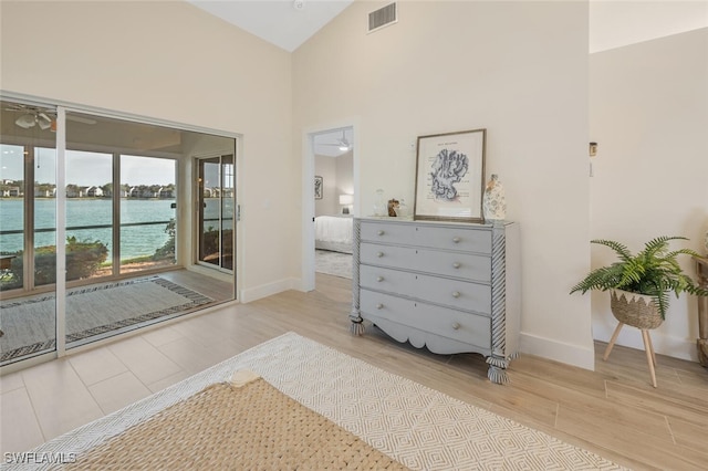 bedroom with visible vents, baseboards, wood finished floors, and access to exterior