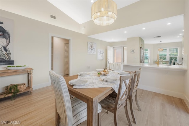 dining area with light wood-style floors, visible vents, recessed lighting, and lofted ceiling