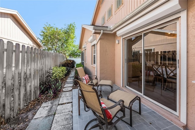 view of patio featuring fence