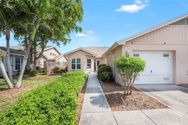 single story home with a garage, stucco siding, driveway, and fence