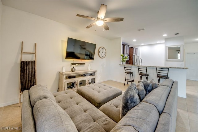 living room with a ceiling fan, visible vents, light tile patterned floors, baseboards, and recessed lighting