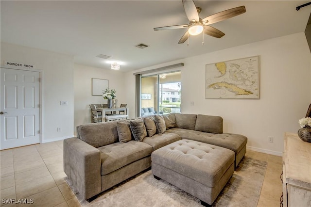living room featuring baseboards, ceiling fan, light tile patterned flooring, and visible vents