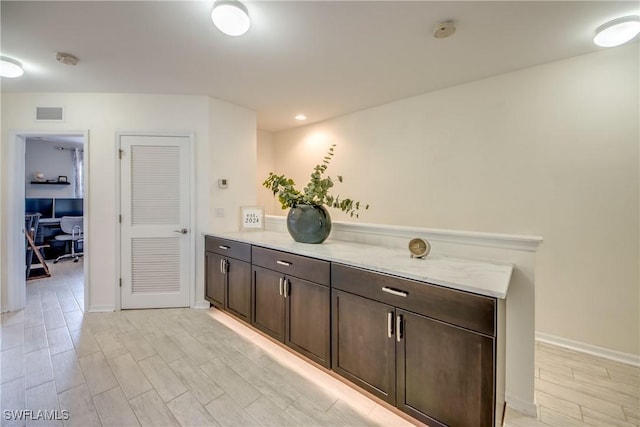 bar featuring baseboards and visible vents