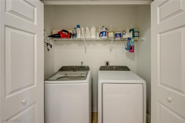 clothes washing area with washer and dryer and laundry area