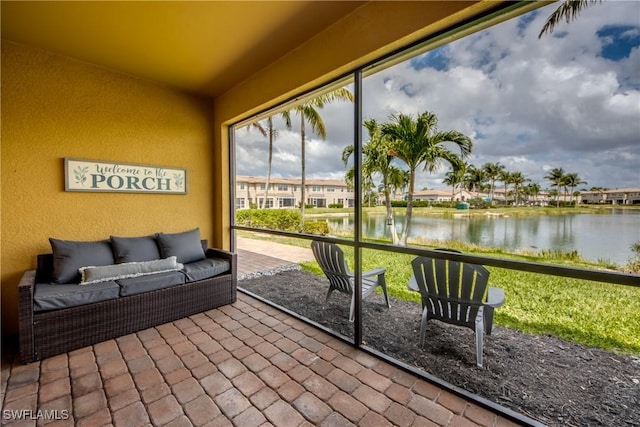 sunroom with a water view and an outdoor hangout area