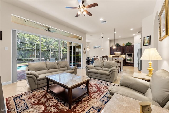 living room featuring light tile patterned floors, ceiling fan, recessed lighting, and visible vents