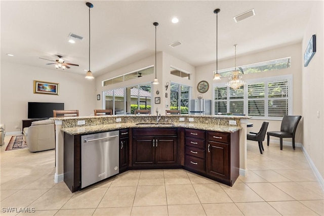 kitchen with stainless steel dishwasher, a sink, visible vents, open floor plan, and a ceiling fan