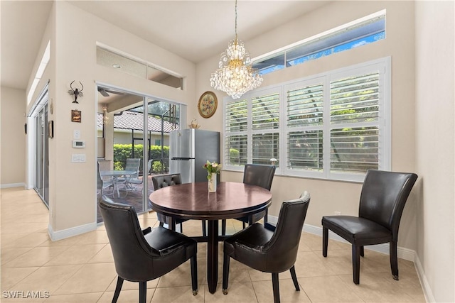 dining room featuring baseboards, light tile patterned floors, and a notable chandelier