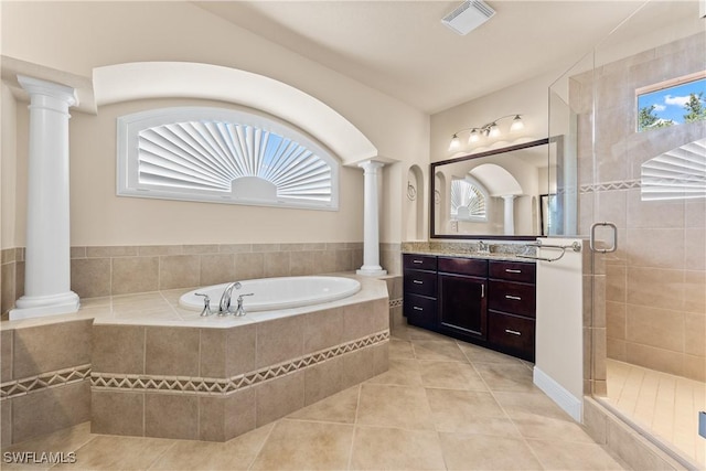 bathroom featuring tile patterned flooring, visible vents, a wealth of natural light, and ornate columns