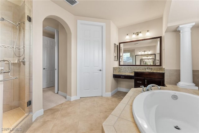 bathroom with visible vents, a stall shower, ornate columns, a garden tub, and tile patterned flooring