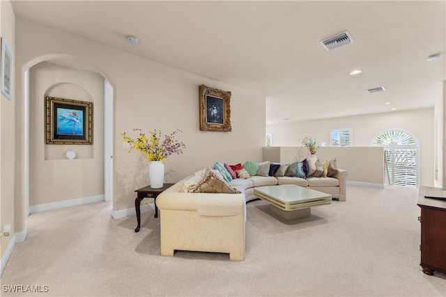 living area with recessed lighting, visible vents, light carpet, and baseboards