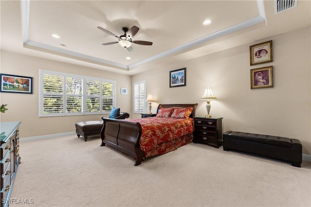 bedroom with light colored carpet, visible vents, a tray ceiling, baseboards, and recessed lighting
