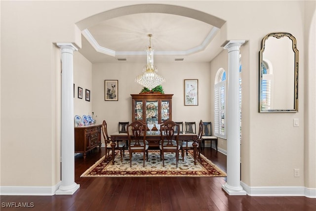 dining area with visible vents, dark wood-style floors, and arched walkways