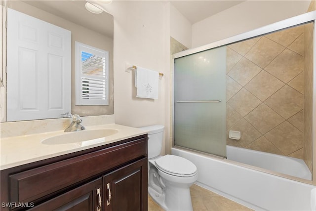 bathroom with tile patterned floors, toilet, enclosed tub / shower combo, and vanity