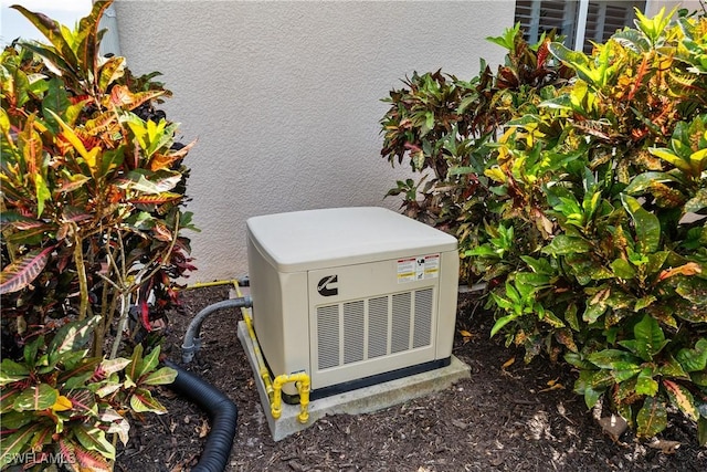 exterior details with a power unit and stucco siding