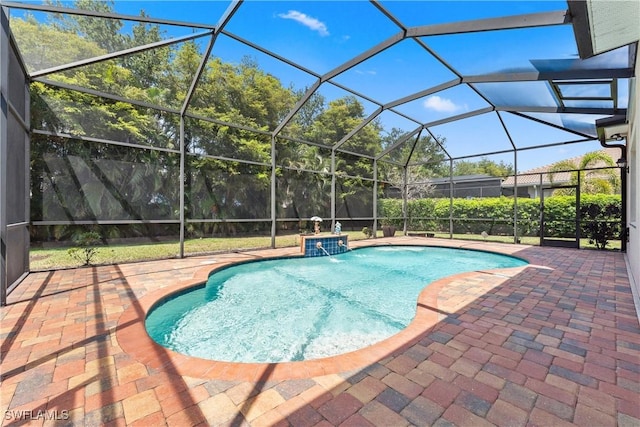 outdoor pool with a lanai and a patio