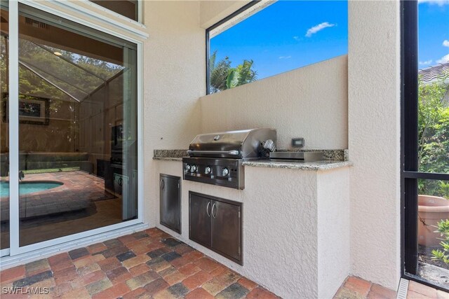 view of patio featuring area for grilling and a grill
