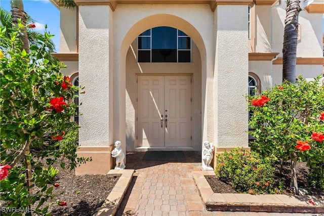 entrance to property featuring stucco siding