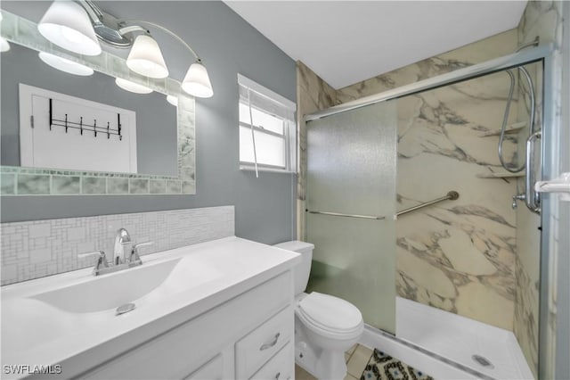 1015 Tropic Ter, North Fort Myers, FL 33903 - bathroom featuring toilet, decorative backsplash, a marble finish shower, and vanity