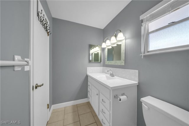 1015 Tropic Ter, North Fort Myers, FL 33903 - half bathroom featuring vanity, baseboards, tile patterned floors, and toilet