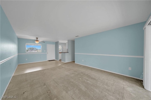 1015 Tropic Ter, North Fort Myers, FL 33903 - unfurnished living room with baseboards, carpet, and a ceiling fan