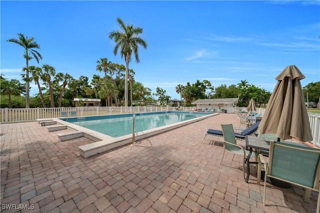 1015 Tropic Ter, North Fort Myers, FL 33903 - community pool with a patio and fence