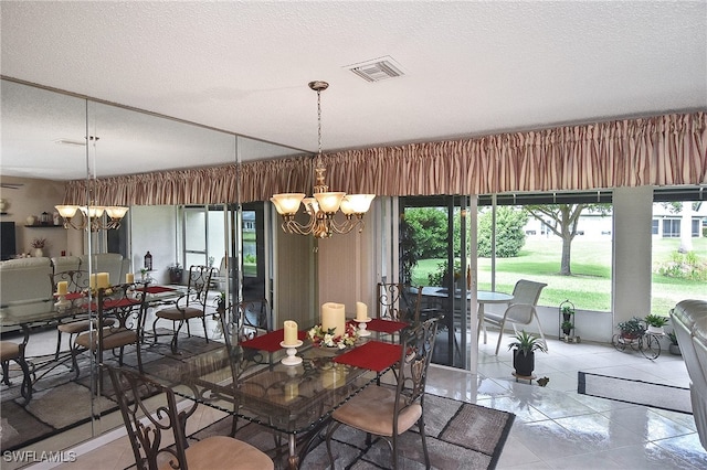 tiled dining space featuring visible vents, a textured ceiling, a chandelier, and a healthy amount of sunlight
