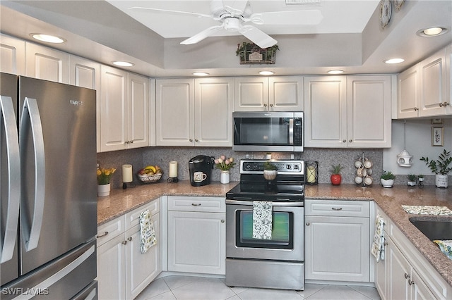 kitchen with appliances with stainless steel finishes, recessed lighting, a ceiling fan, decorative backsplash, and light tile patterned floors