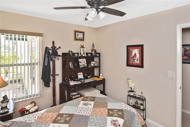 bedroom featuring a ceiling fan and baseboards