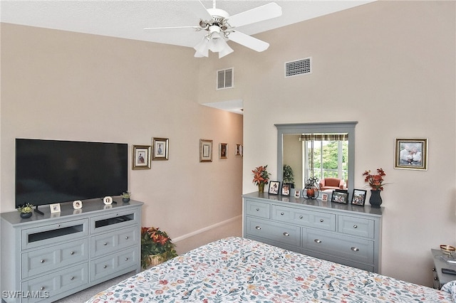 bedroom with visible vents, carpet floors, and high vaulted ceiling