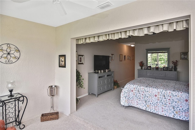 bedroom featuring carpet floors, ceiling fan, and visible vents