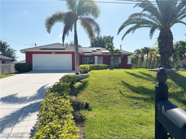3007 NE 4th Ave, Cape Coral, FL 33909 - single story home featuring driveway, solar panels, a garage, fence, and a front lawn